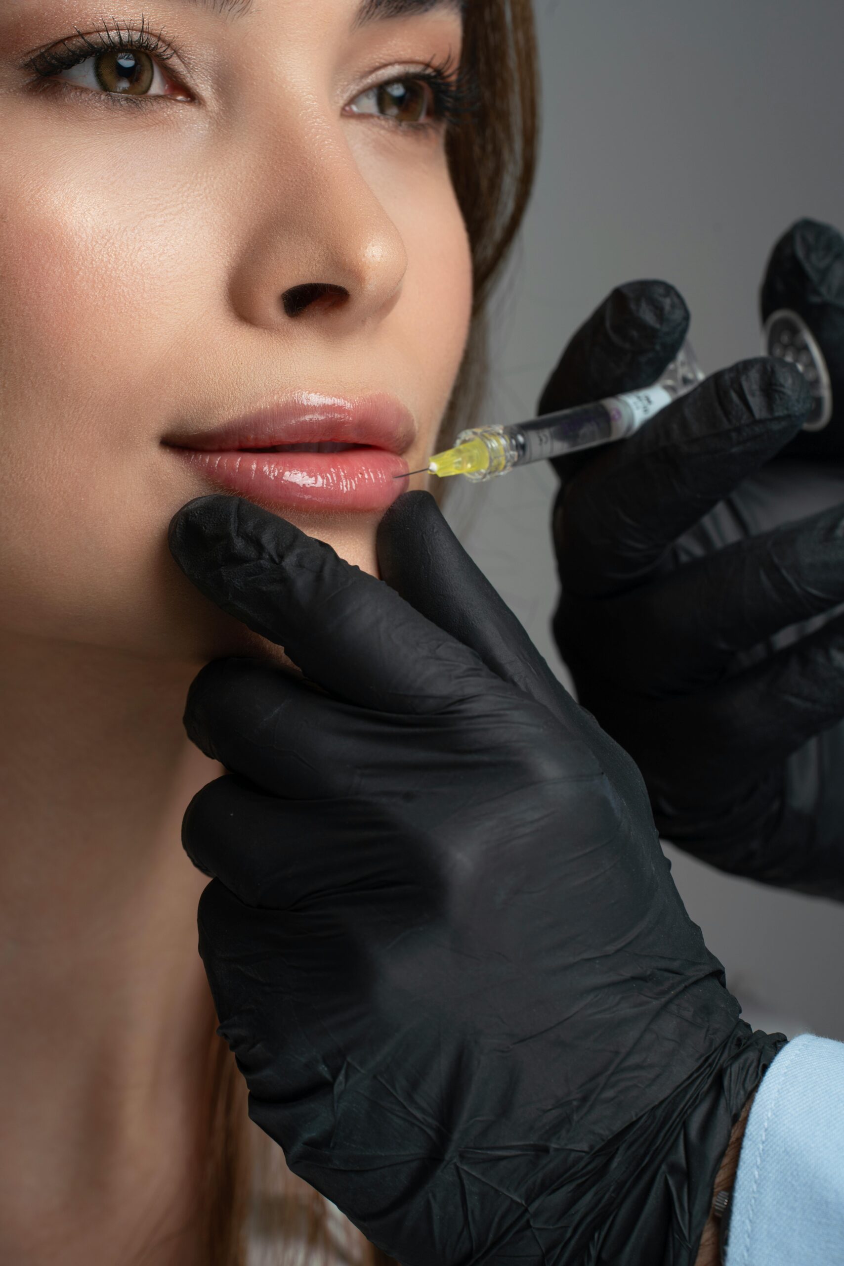Home Detailed image of a cosmetic lip injection being administered by a professional.